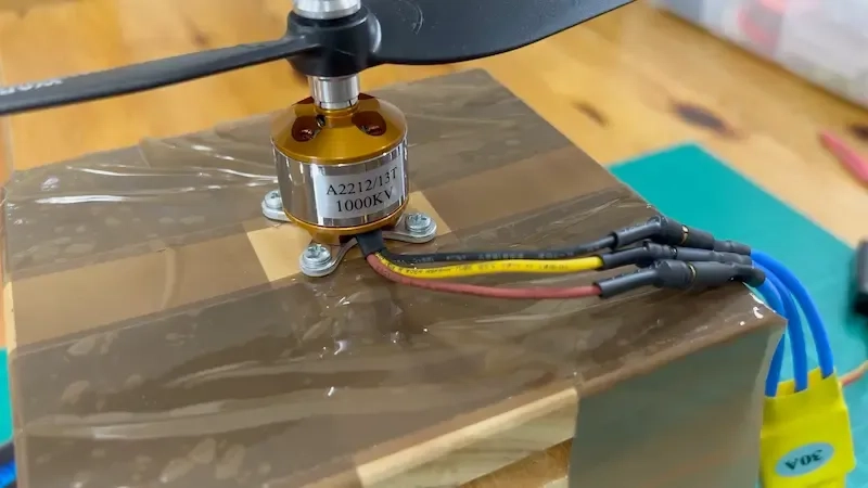 1000kV brushless motor mounted on a piece of wood.