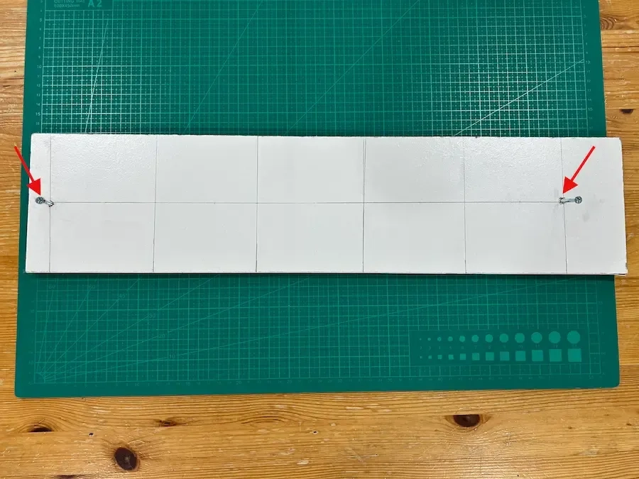 wood-piece-with-two-screws-fixed-at-50cm-apart.