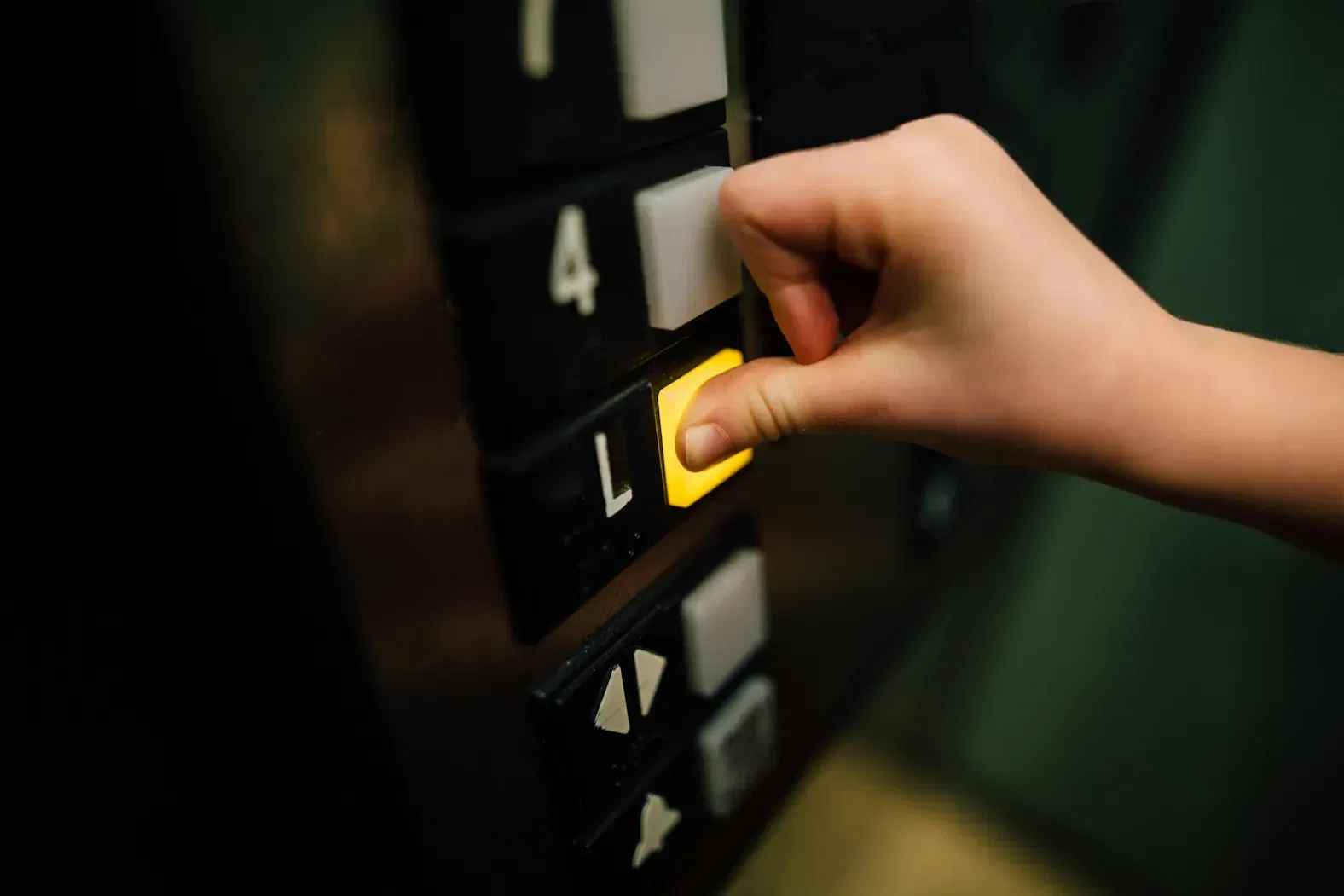 a person pressing a lift button