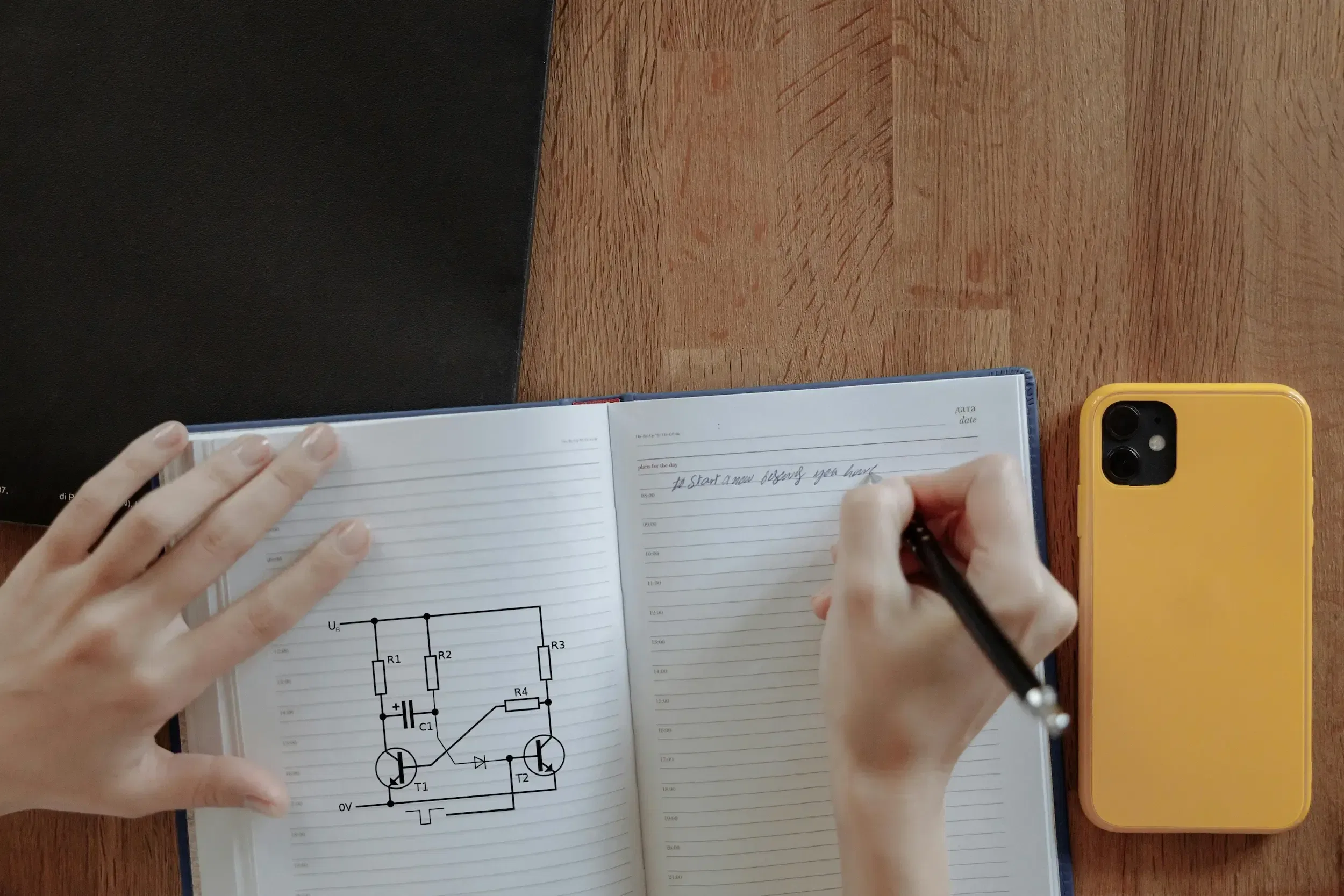 Student taking notes for a circuit