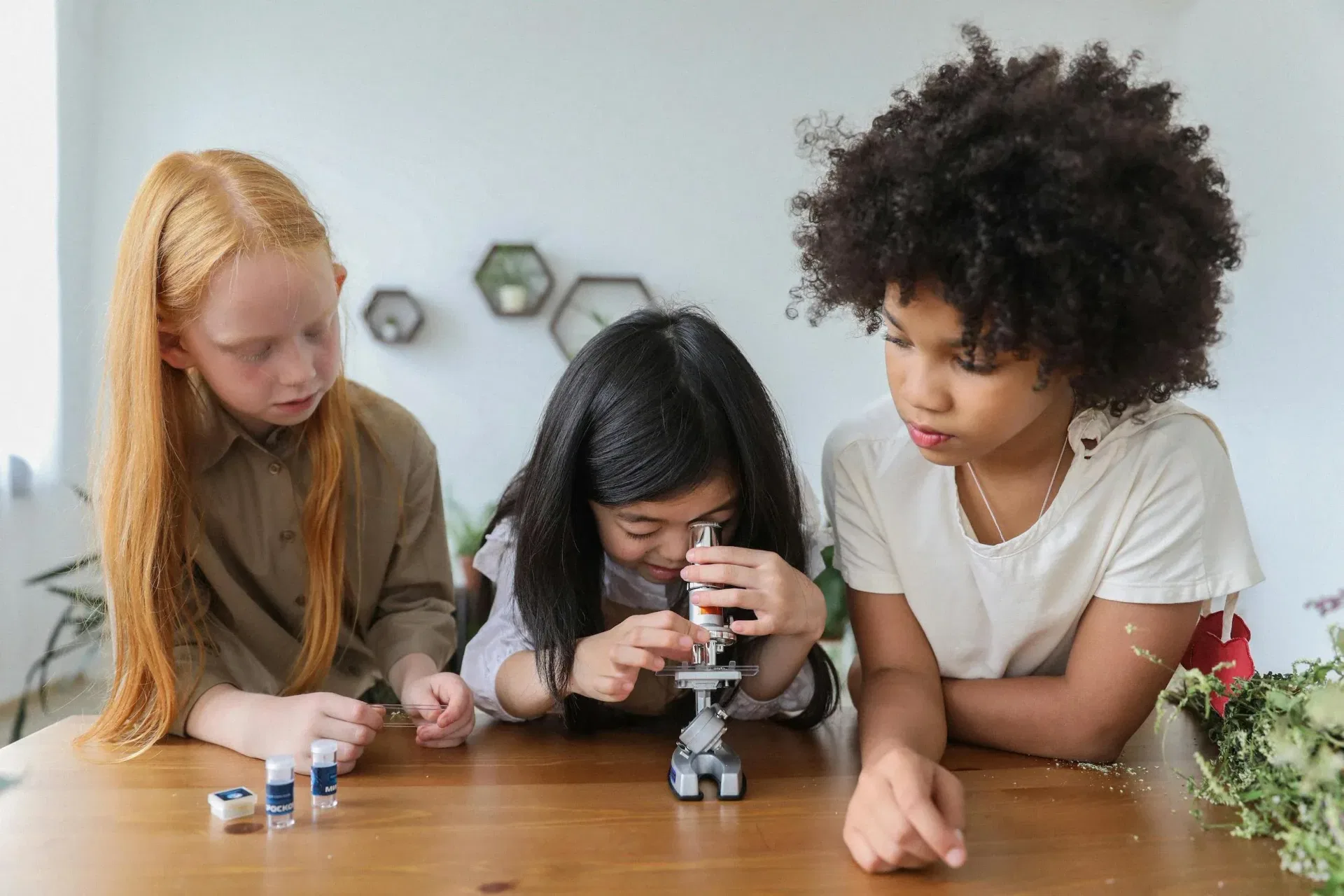 Children looking into a microscop in turns