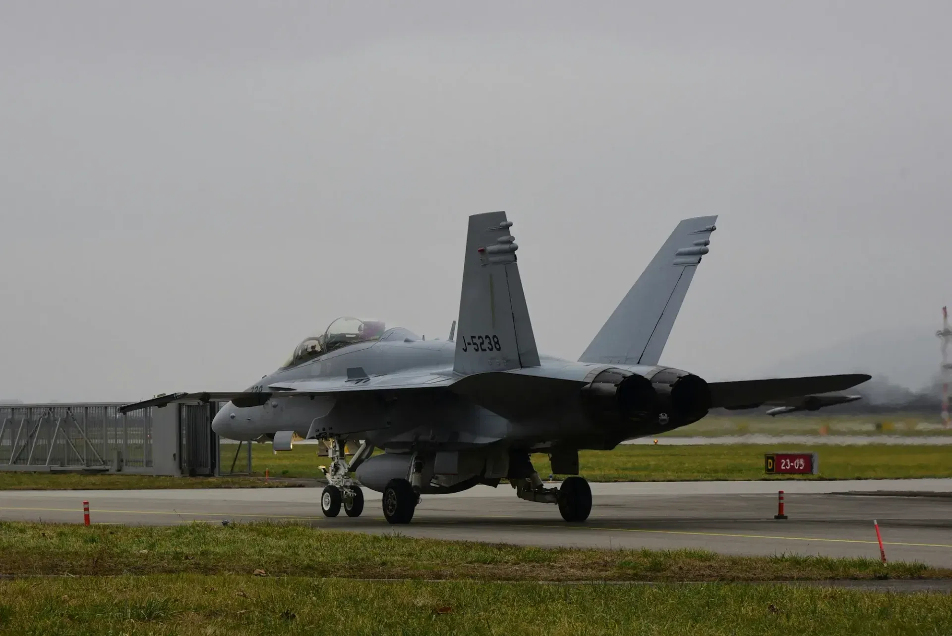 Jet fiighter ready to take off with focus on the tail side